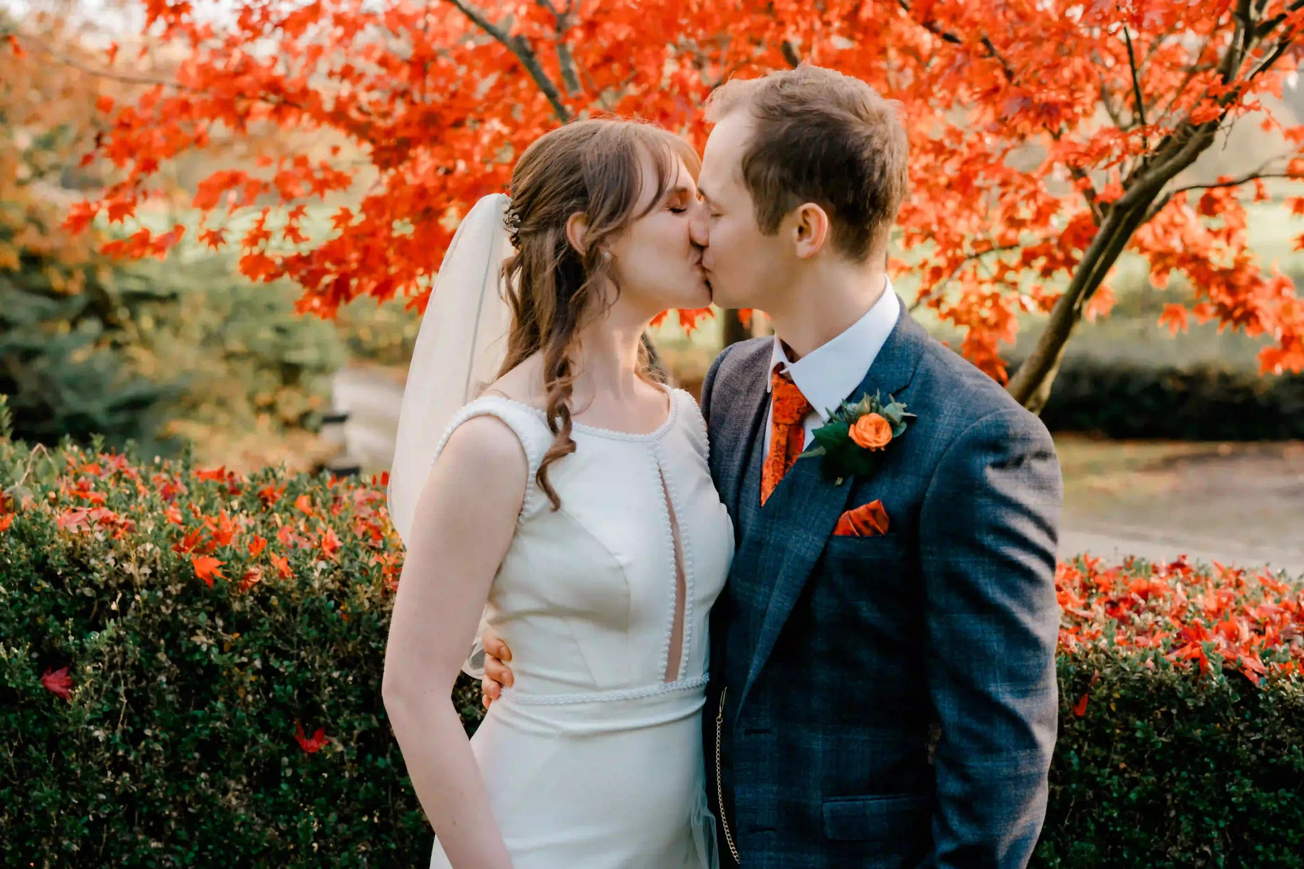 Angharad and Roman Couple standing under tree being photographed
